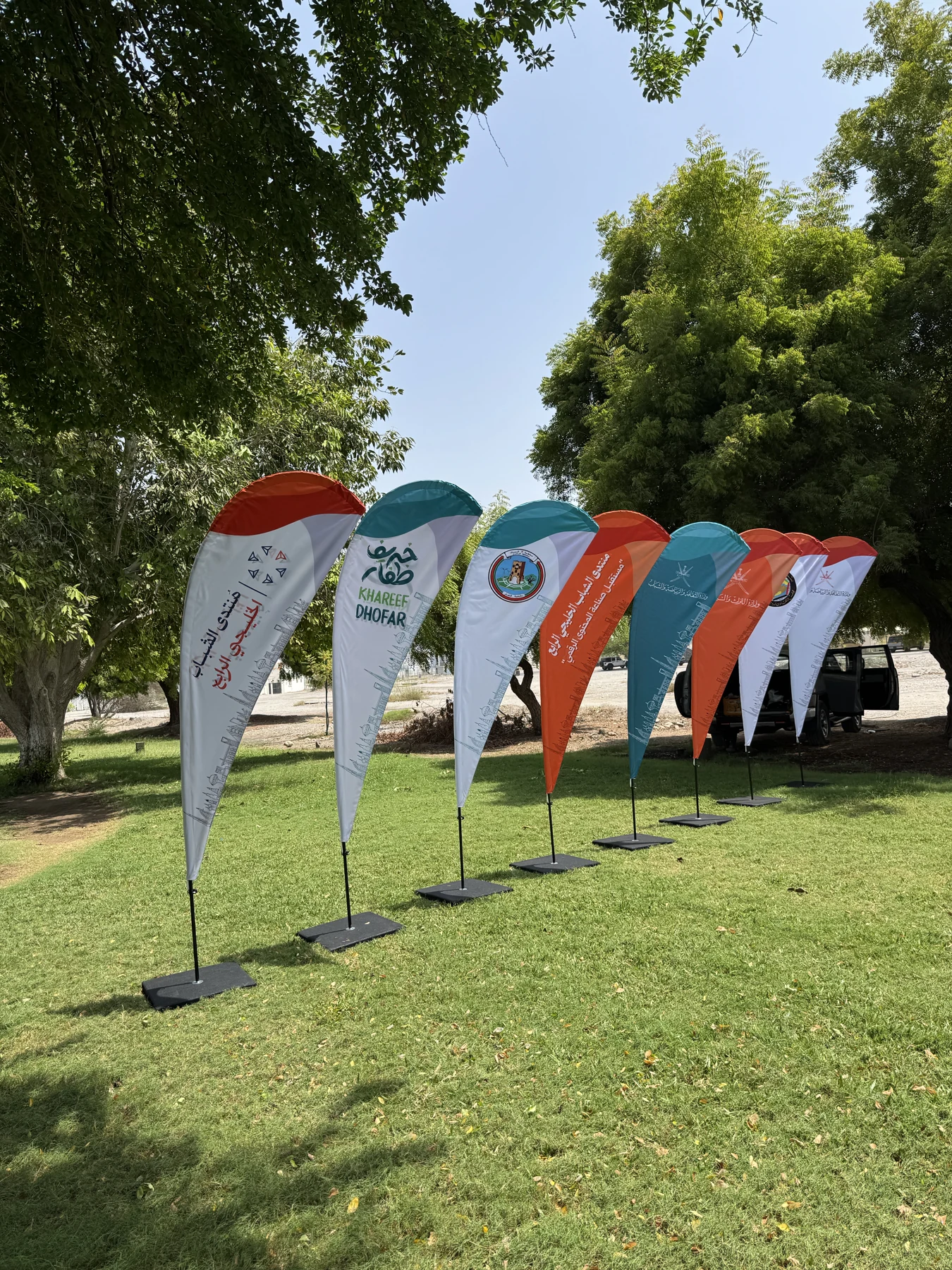 Teardrop flags with event branding on a lawn